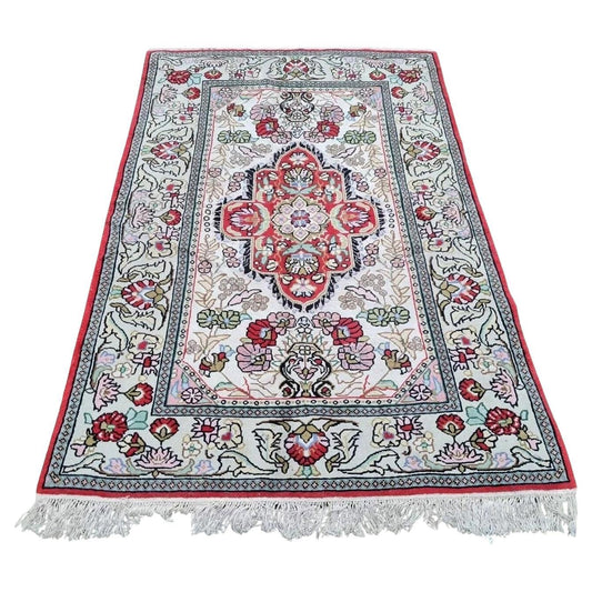 Central medallion of vintage Kazvin rug in red and navy floral motifs

