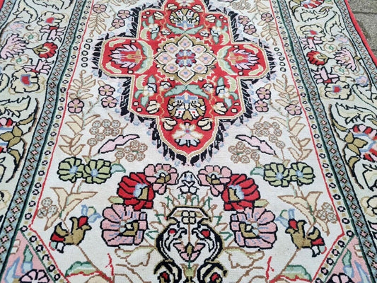 Full view of handmade Persian Kazvin rug with intricate curvilinear design

