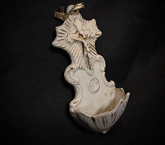 Close-up of porcelain Christ showing esoteric container and minor crack.