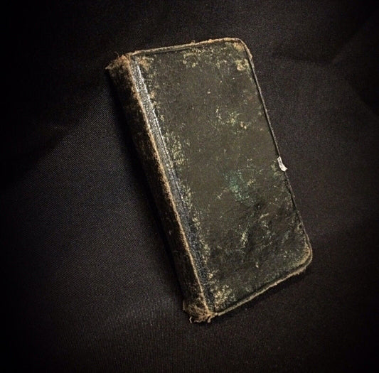 Close-up of the pages inside the antique Roman Missal book, highlighting the text.

