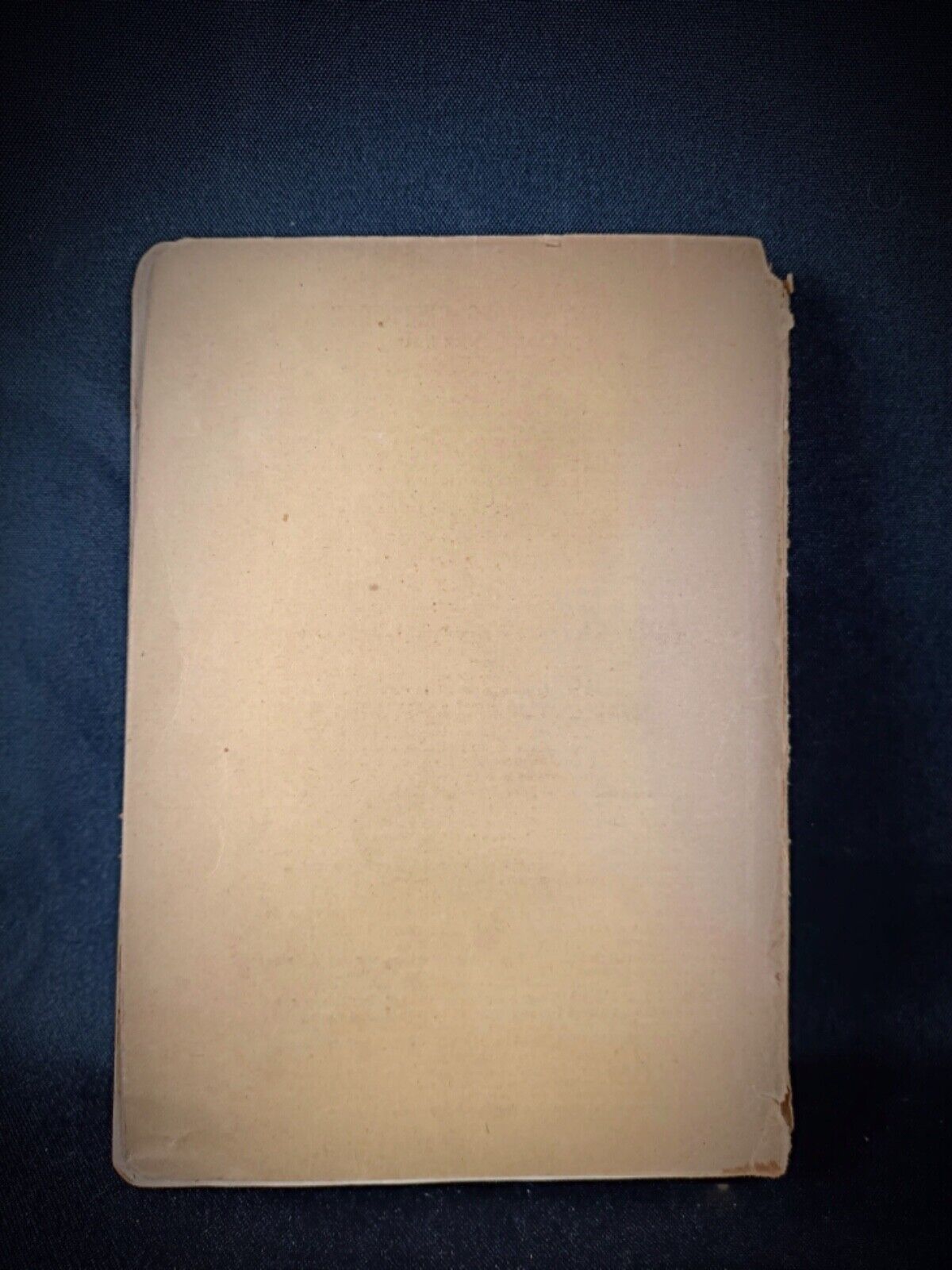 Side view of a rare vintage book on fabric production history
