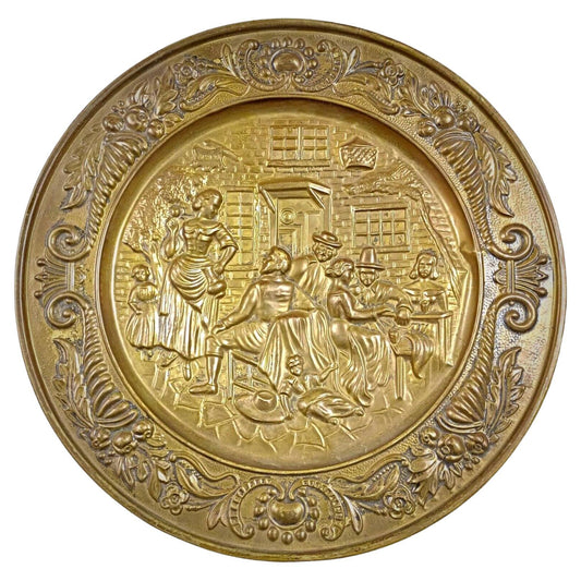 Antique 20th-century brass plate with a repoussé tavern scene
