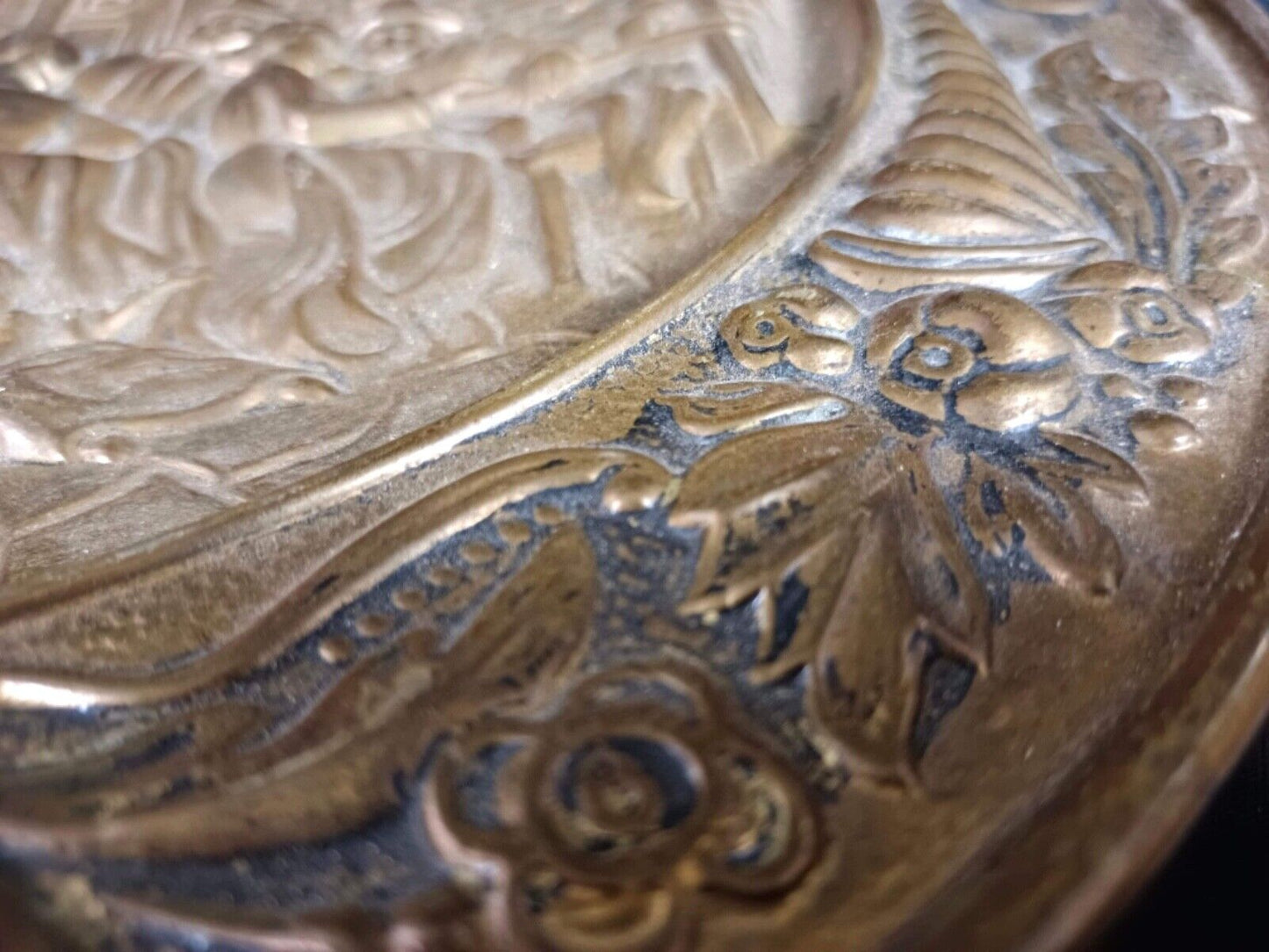 Ornate antique brass plate with light oxidation and patina
