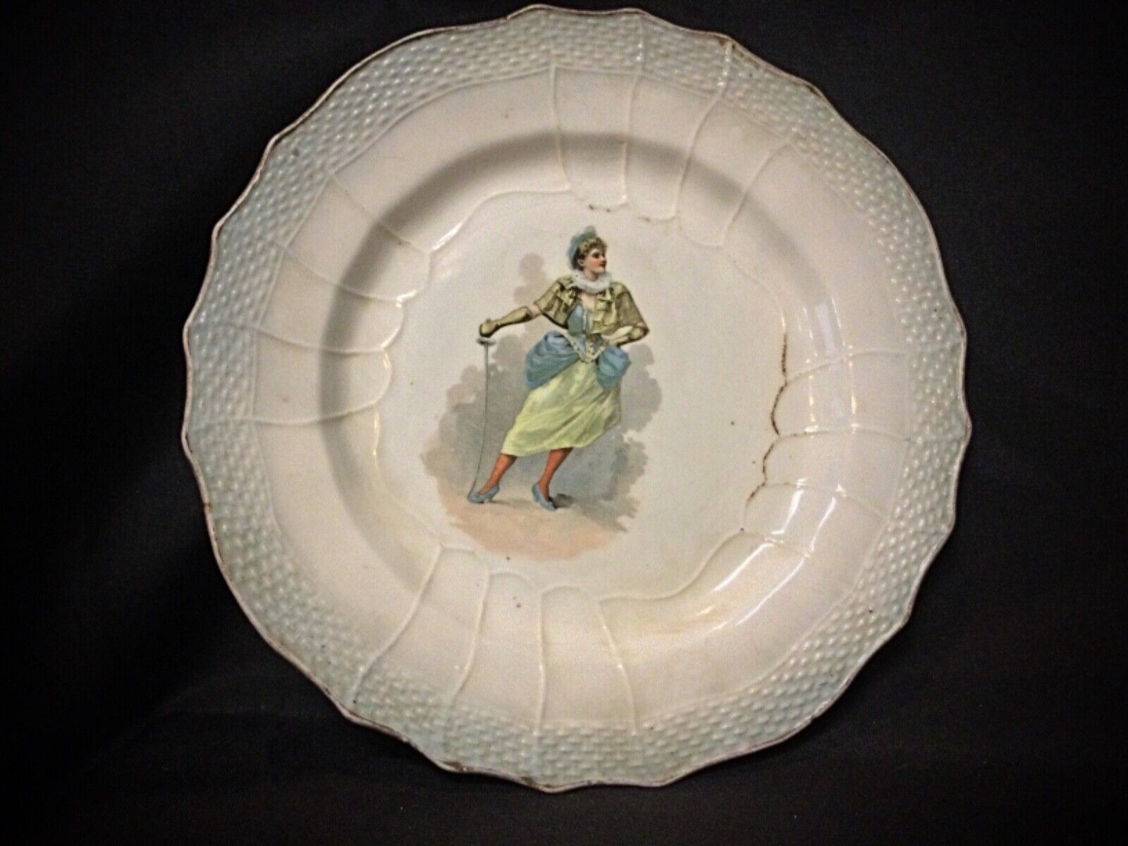 Close-up of the "Woman with a Sword" motif on the antique faience plate.
