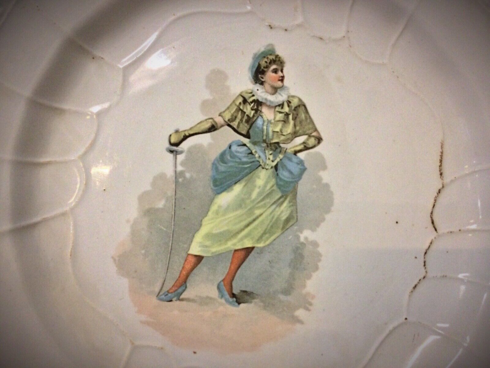 Side view of the 20th-century faience plate, showcasing its depth and glazing.
