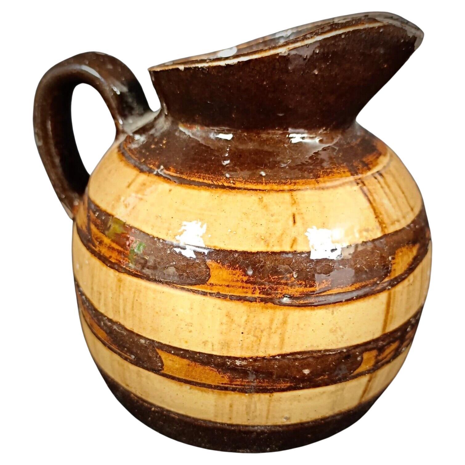 Vintage hand-painted barrel-style clay pitcher with rustic charm

