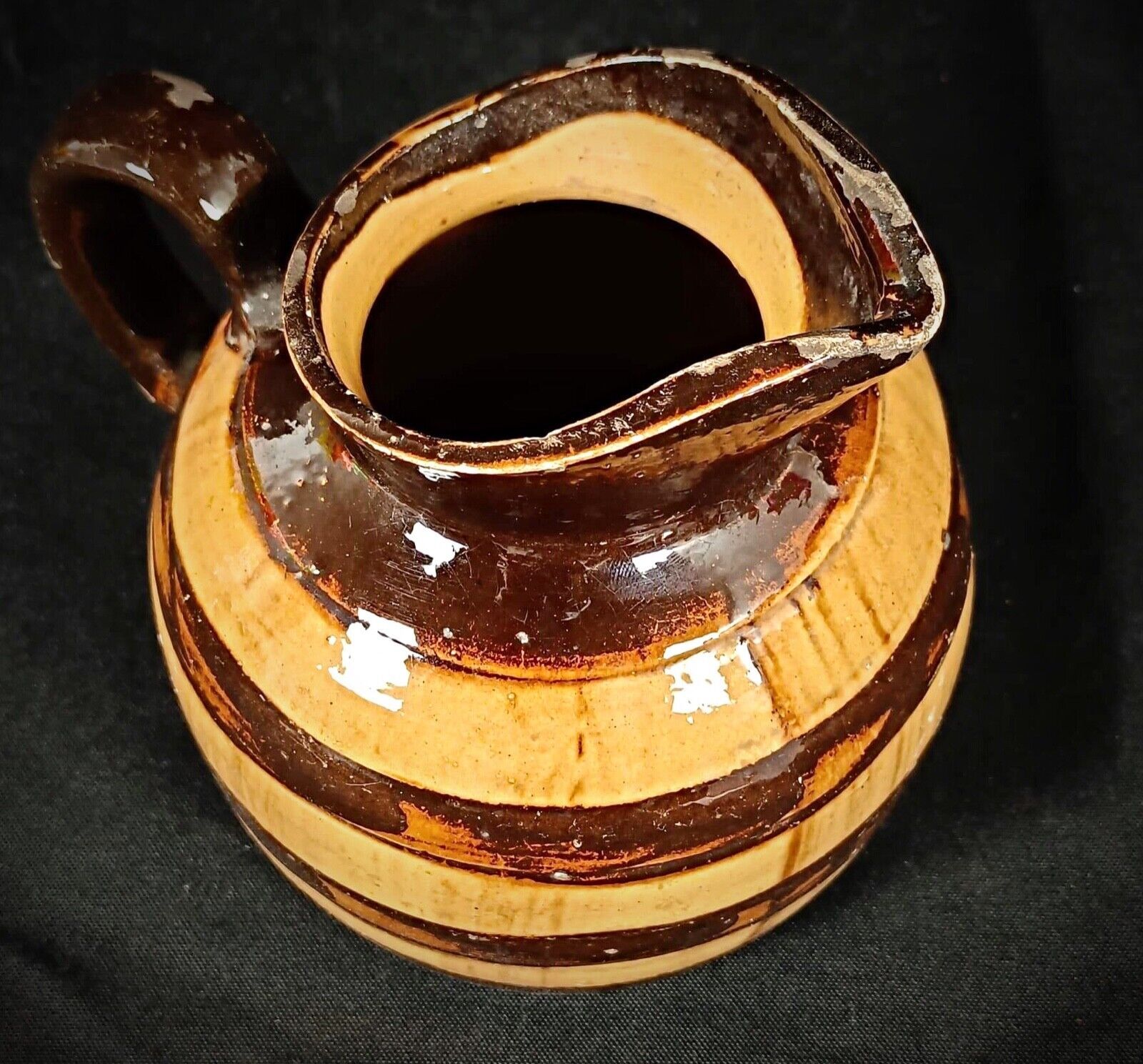 Rustic farmhouse-style ceramic pitcher with intricate design
