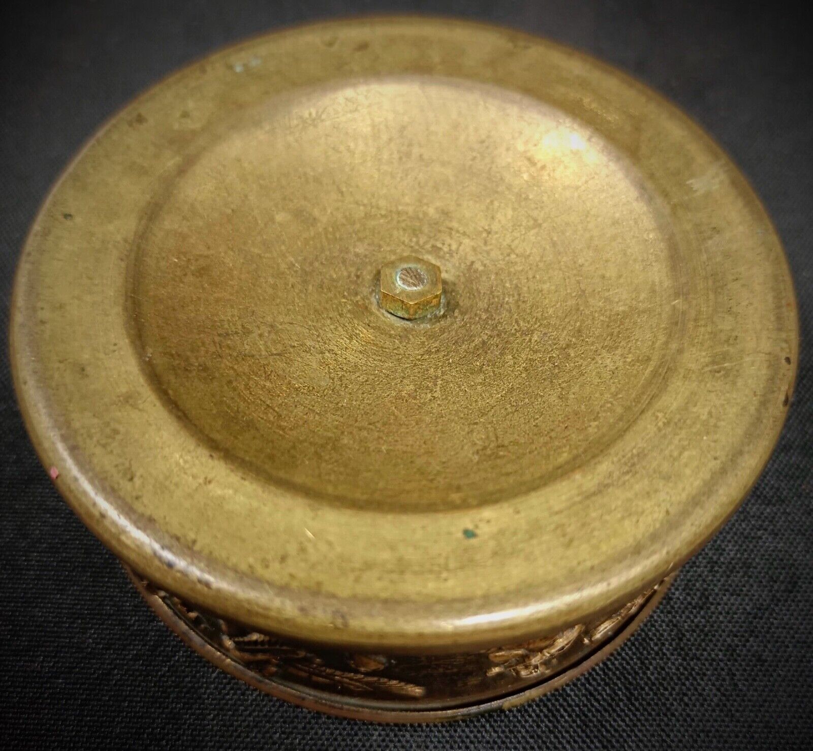 Close-up of the serpent design on the brass trinket dish.
