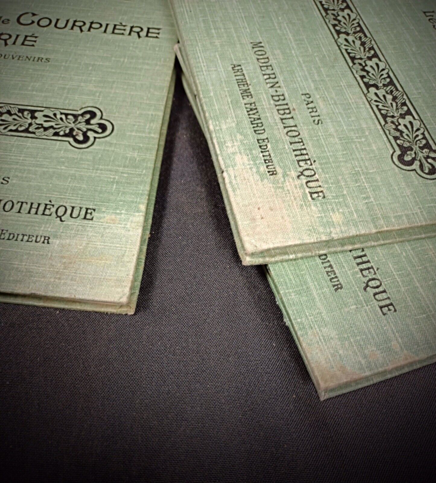 Side view of stacked vintage books Les Yeux Verts, L'Armature, Monsieur de Courpière Marie

