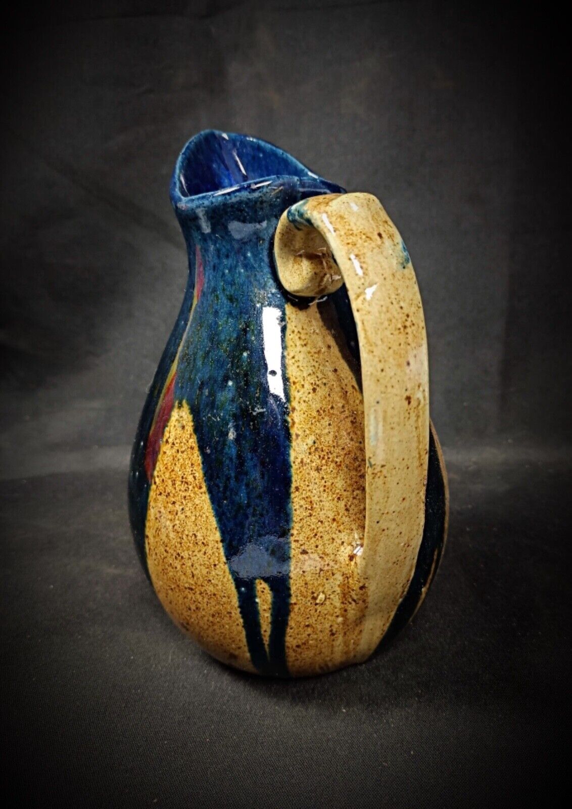 Close-up of enamel finish on terracotta pitcher

