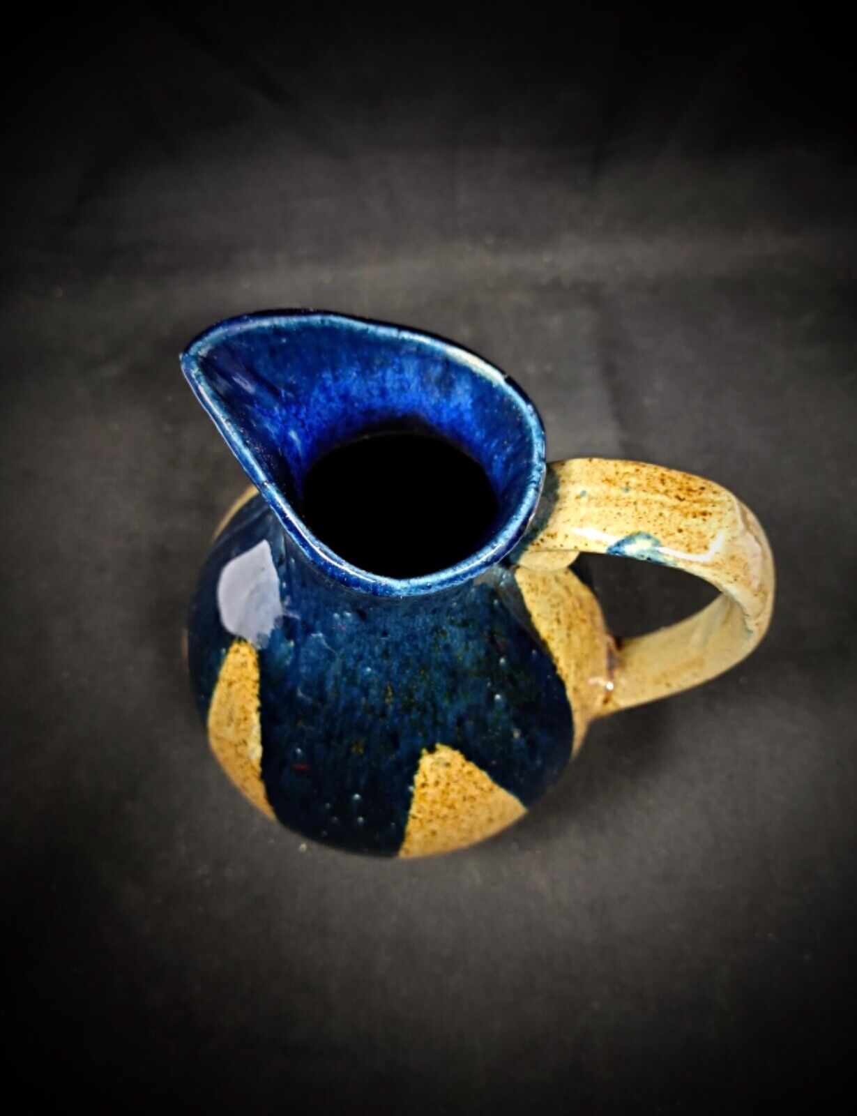 Top-down view of vintage enamel pitcher opening

