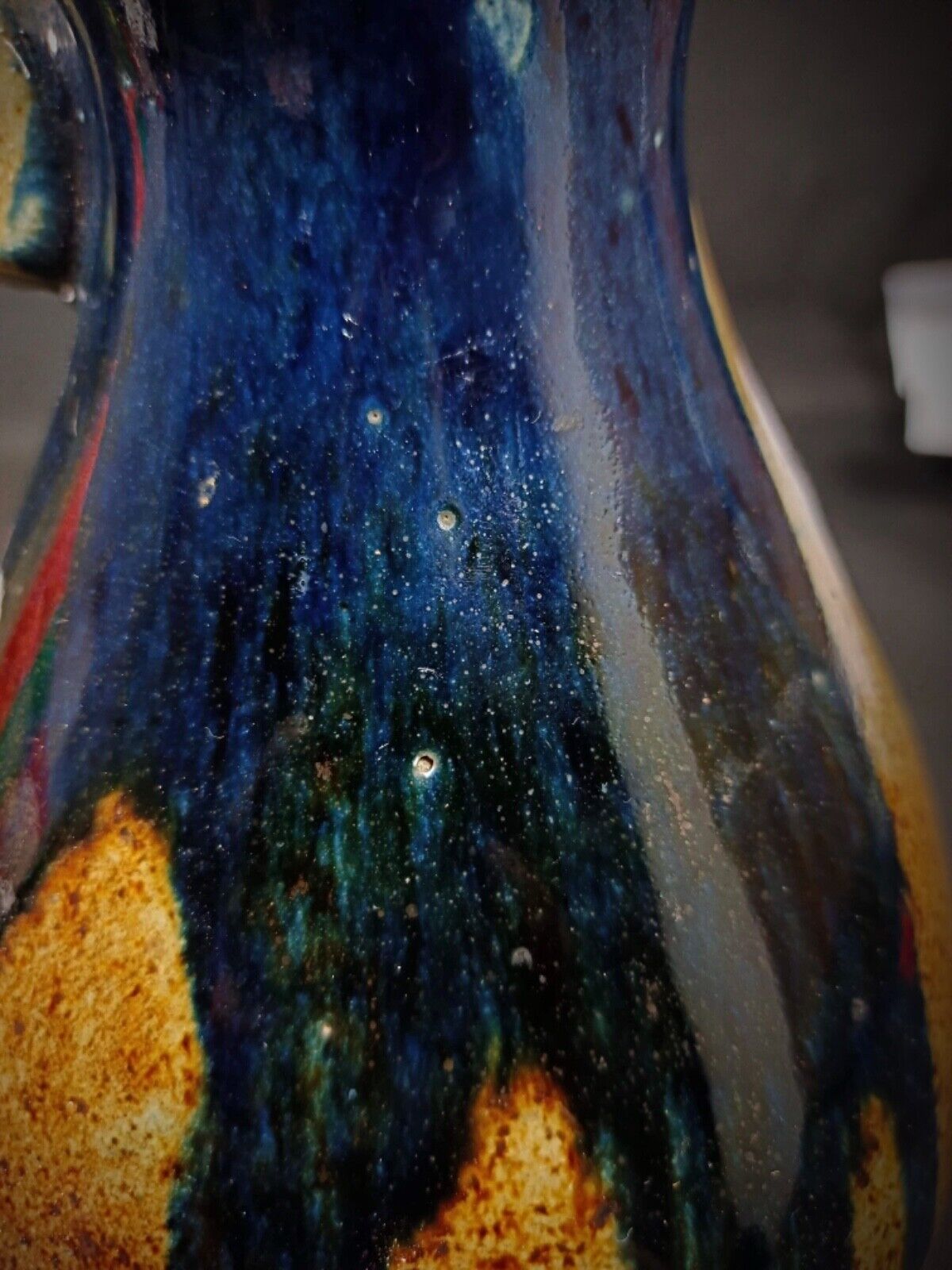 Handle and spout detail of vintage terracotta pitcher

