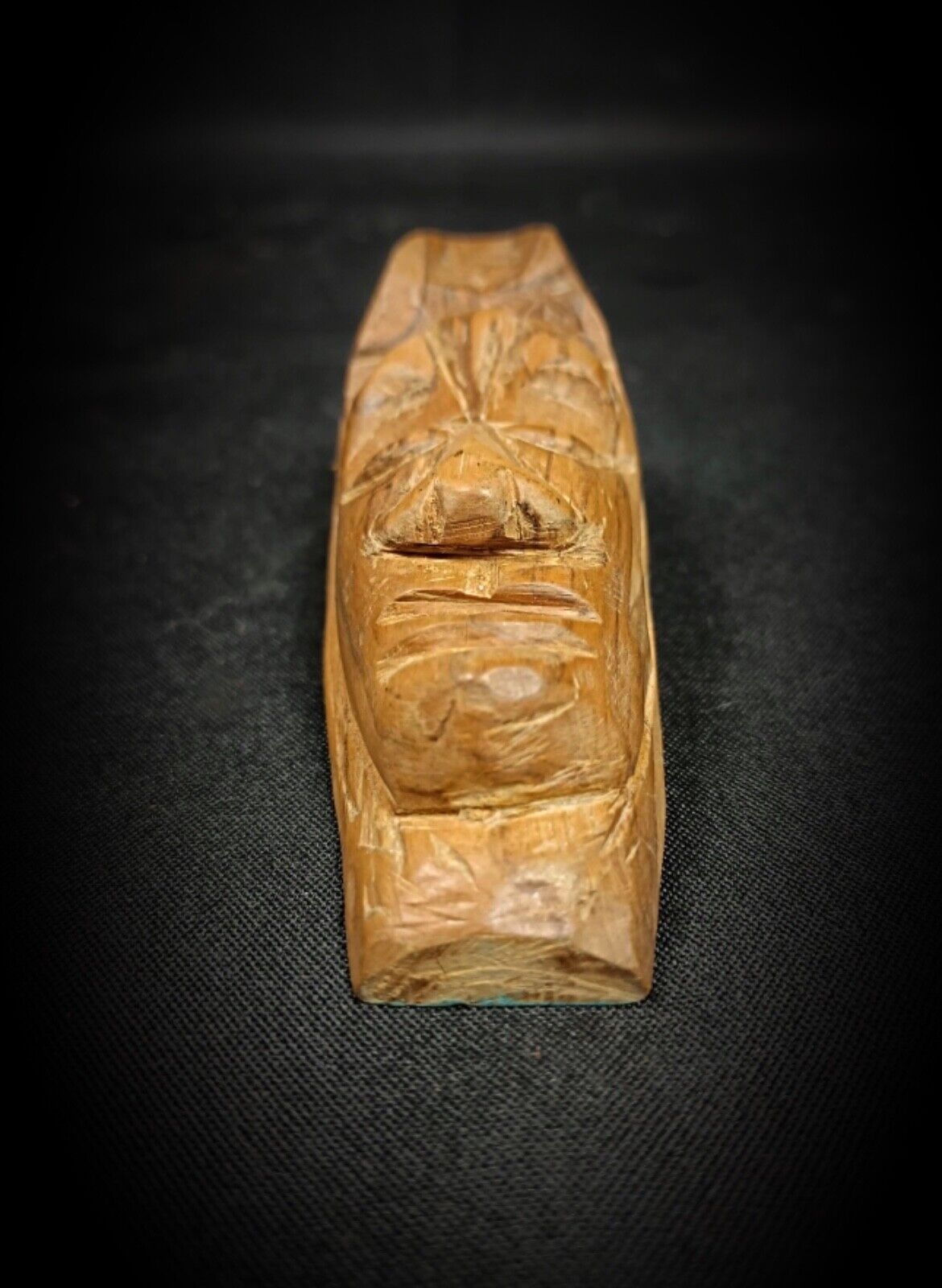 Deeply carved facial features on wooden mask

