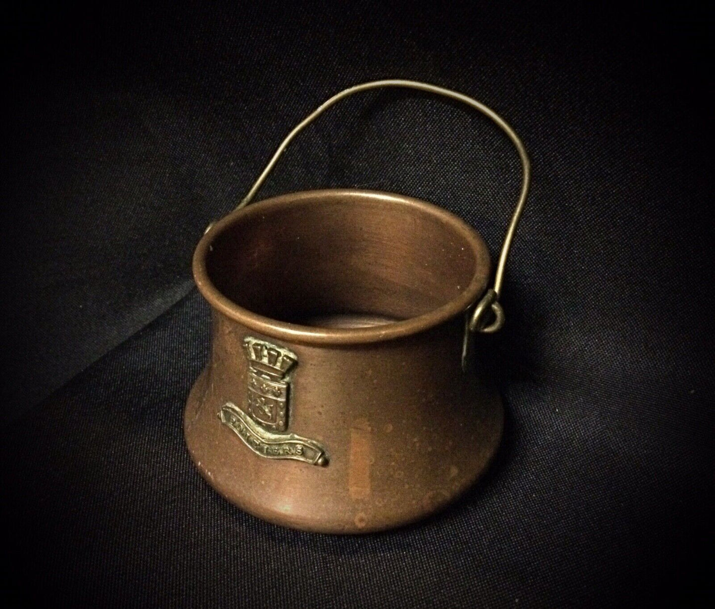 Top-down view of the antique copper cauldron showing its circular shape and craftsmanship.
