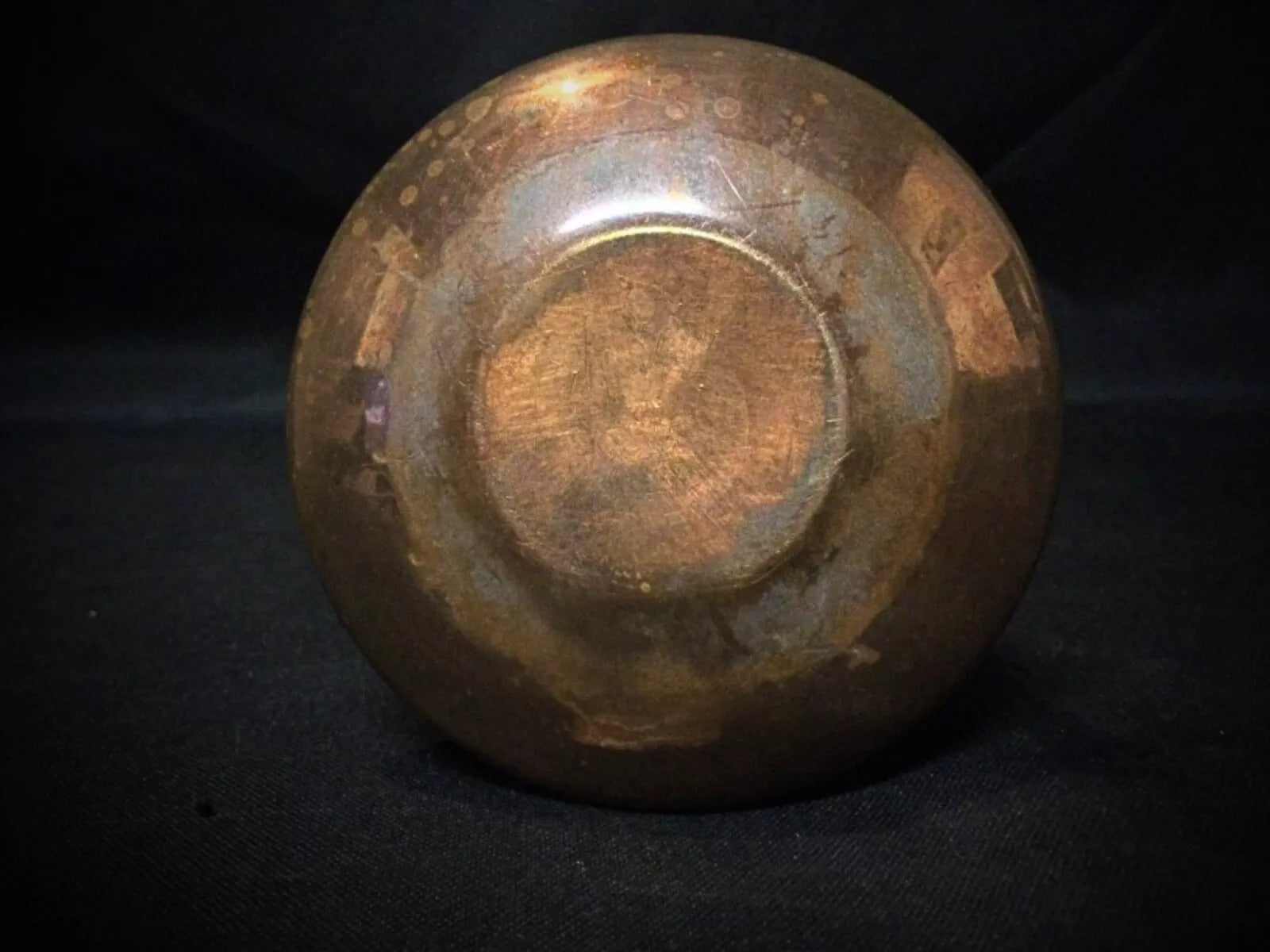 Close-up of the 'Poitiers' engraving on the antique copper cauldron.