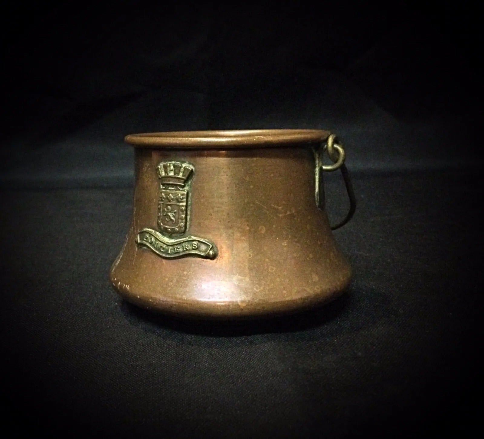 Antique copper cauldron with rich patina, showing its age and fine craftsmanship.