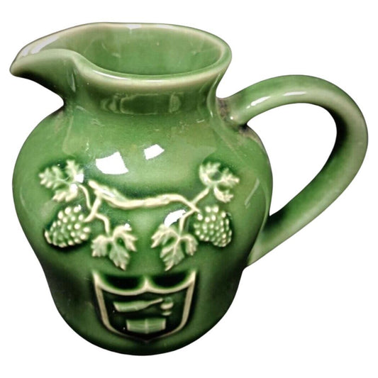 Vintage porcelain pitcher with grapevine design

