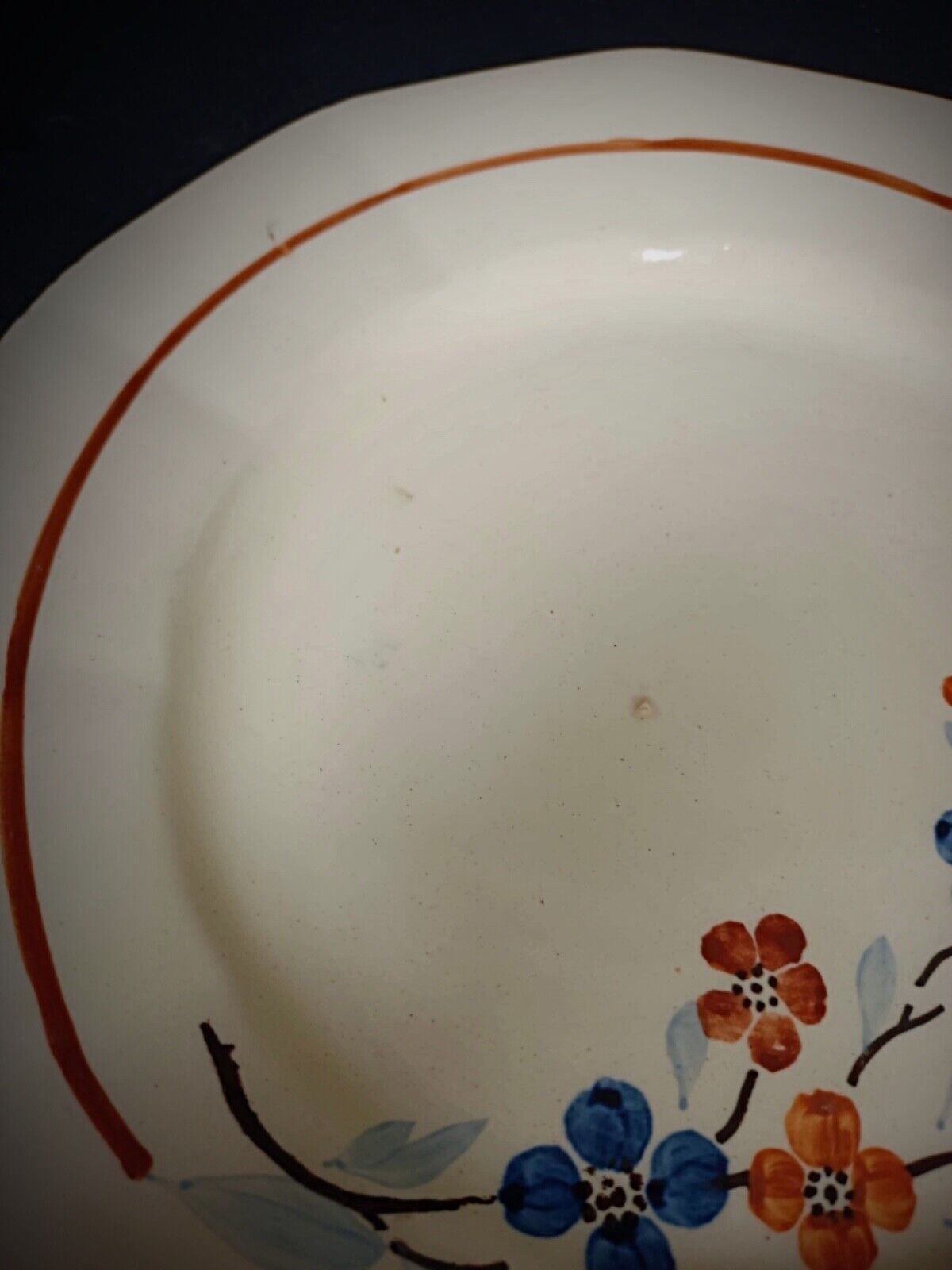 Yellow floral accent on vintage ceramic plate

