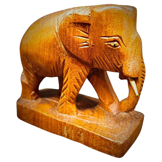 Hand-carved wooden elephant figurine front view

