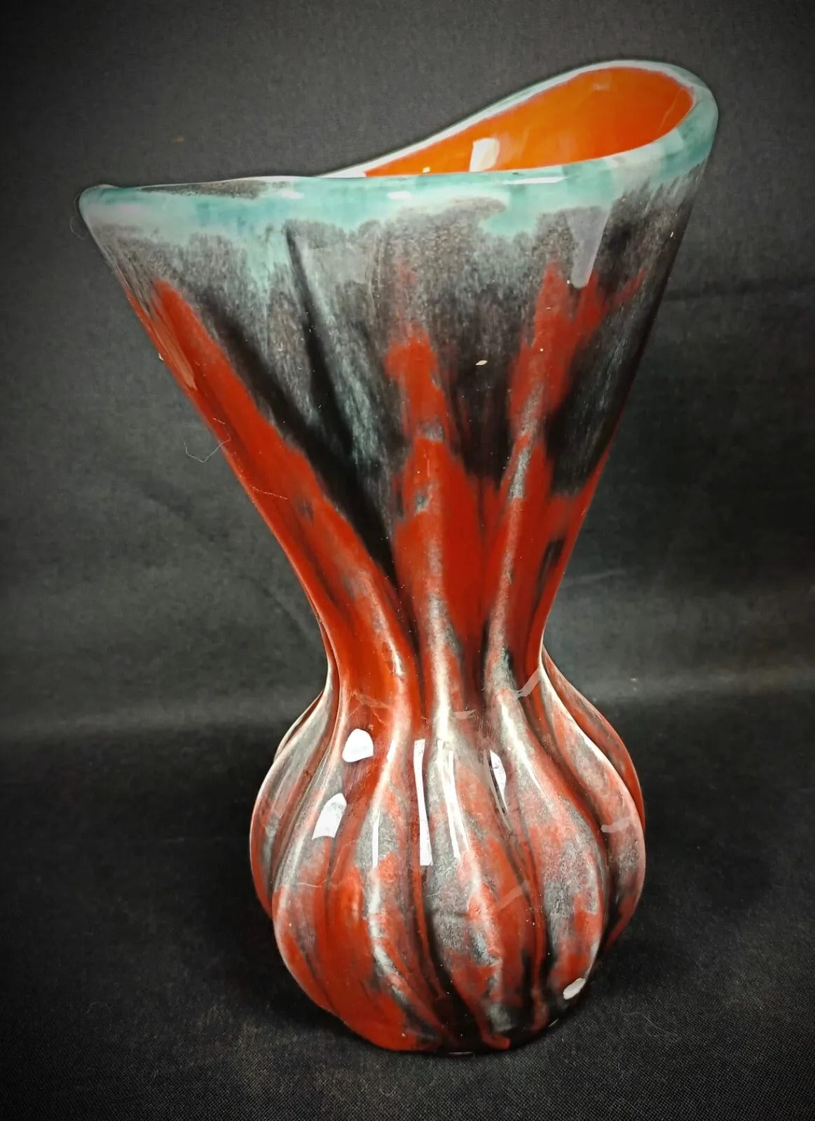 Artist signature detail on pottery base

