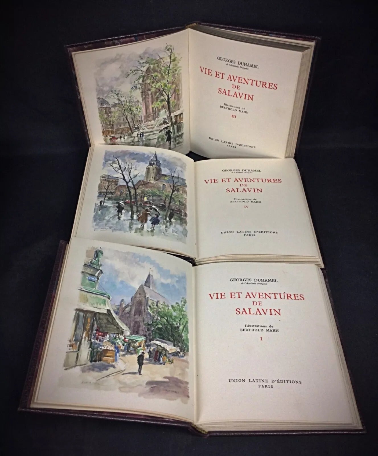 Side profile of the book set showing its thickness and aged paper edges.

