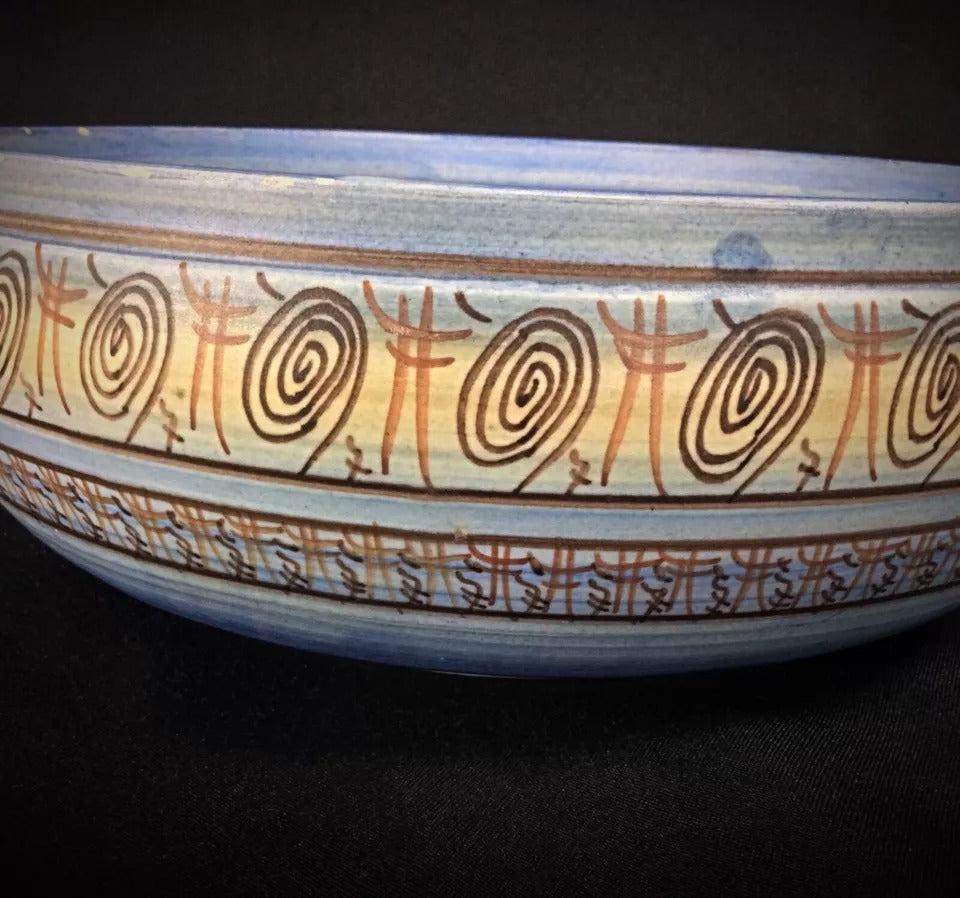 Shot focusing on the intentionally irregular, undulating rim of the bowl.

