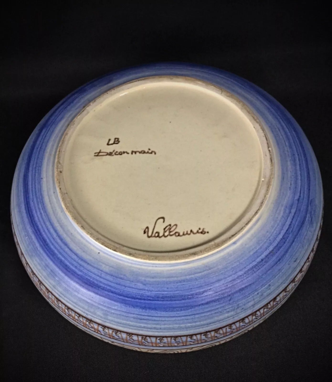 View of the bowl's base, clearly showing the stamped "HB" monogram.

