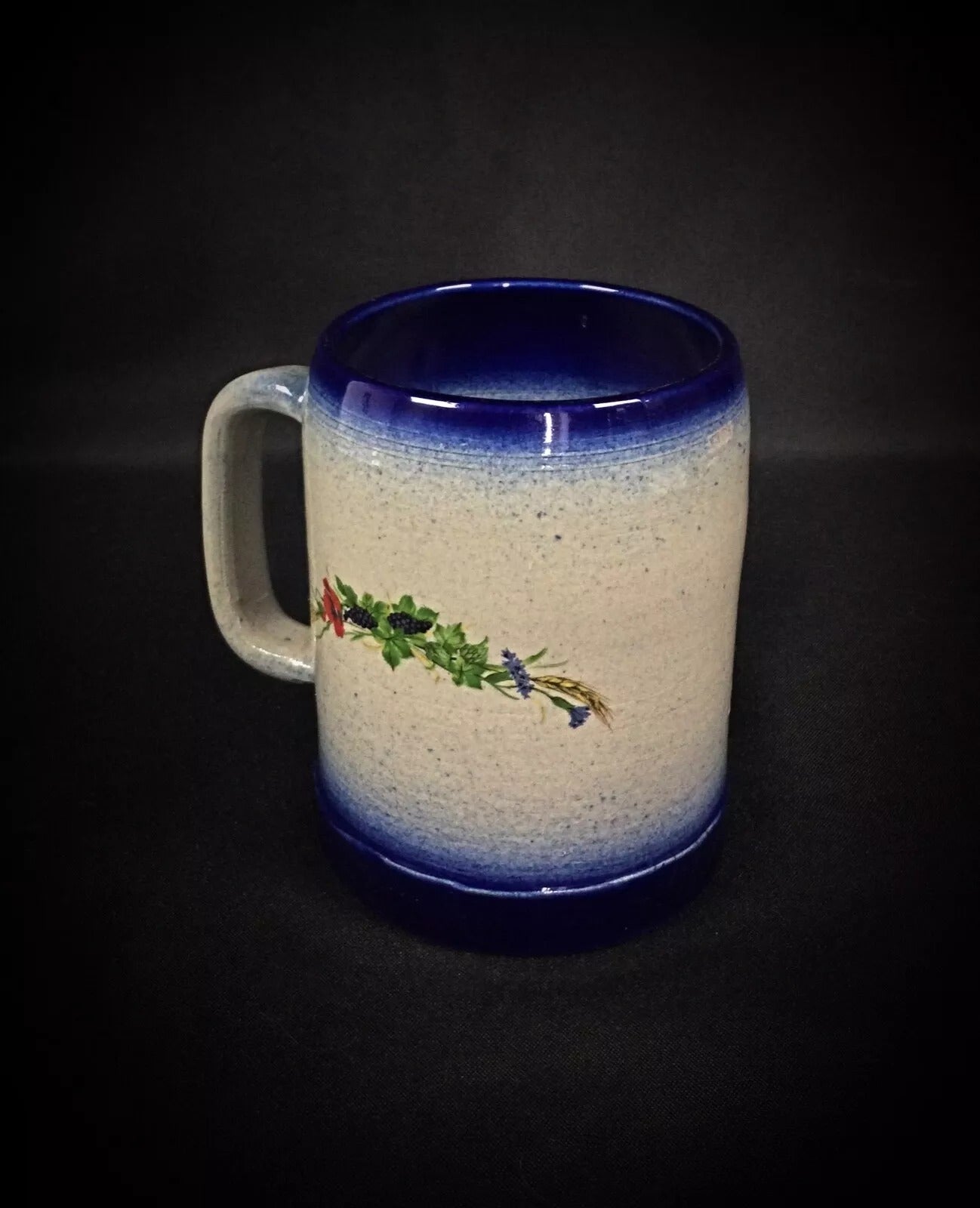 Side view of the mug showcasing its robust, wheel-thrown form and handle.

