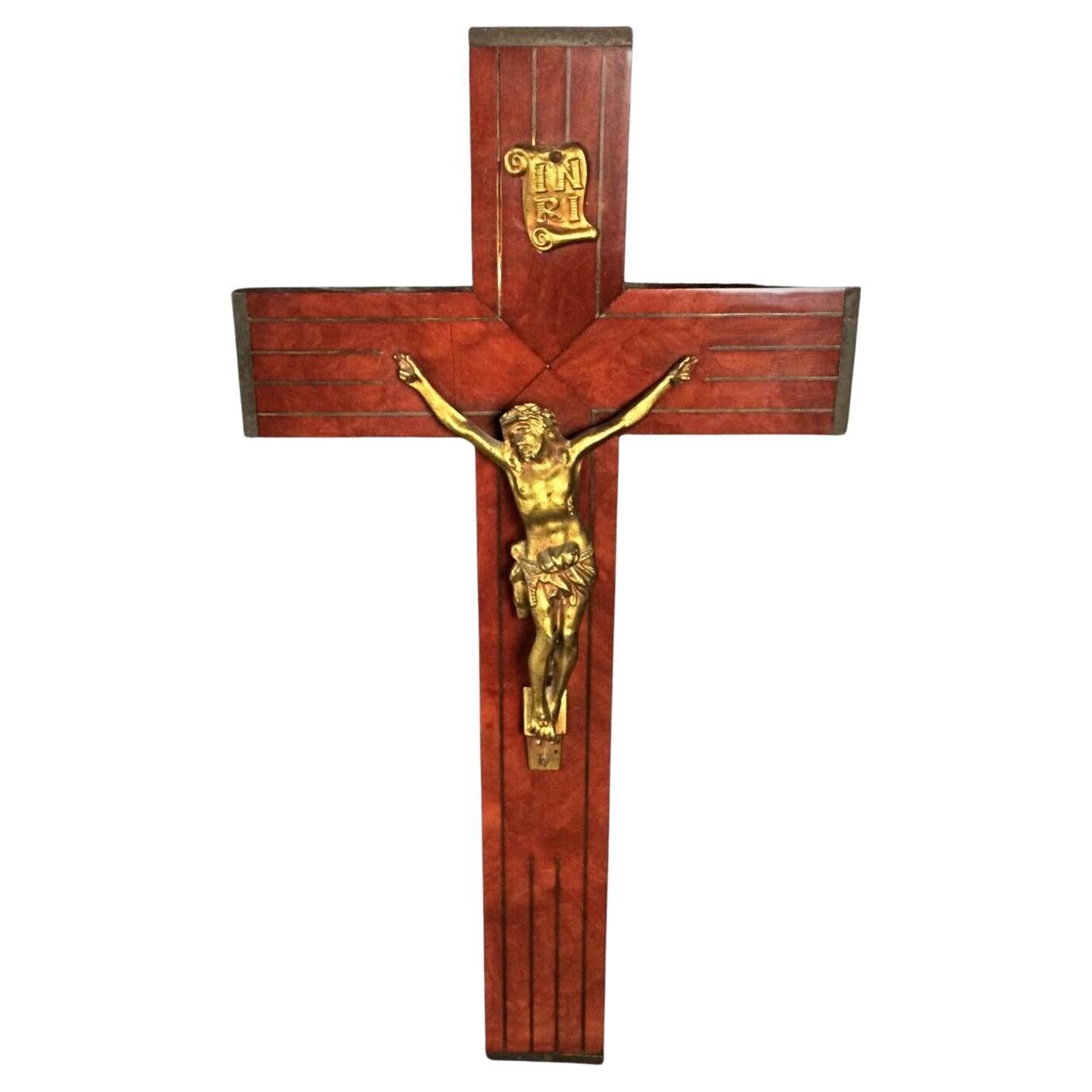 Full frontal view of the large regule crucifix mounted on a wall.

