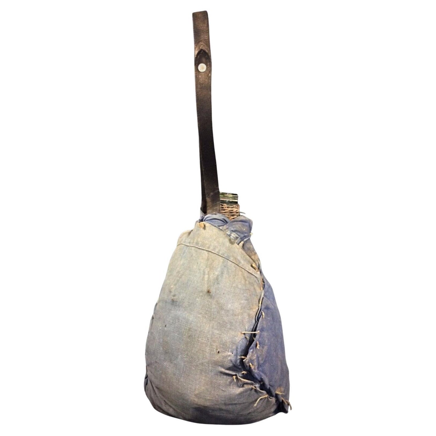 Full frontal view of the vintage French demijohn bottle with its woven wicker case.

