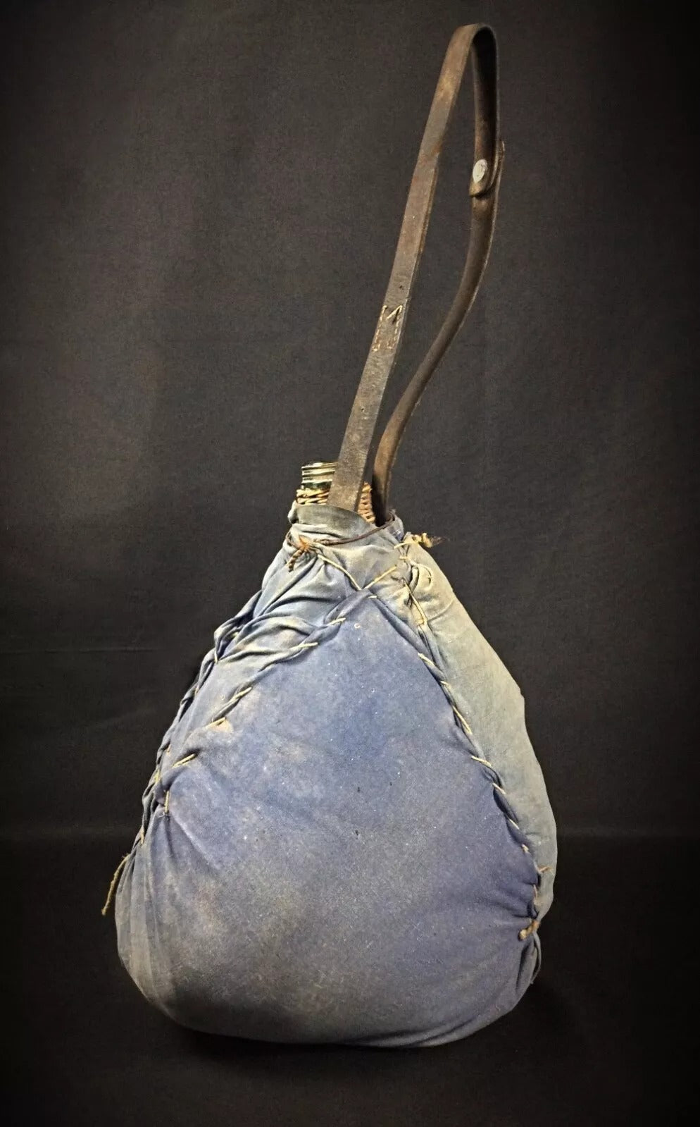 View of the bottle's base and the bottom of the woven case.

