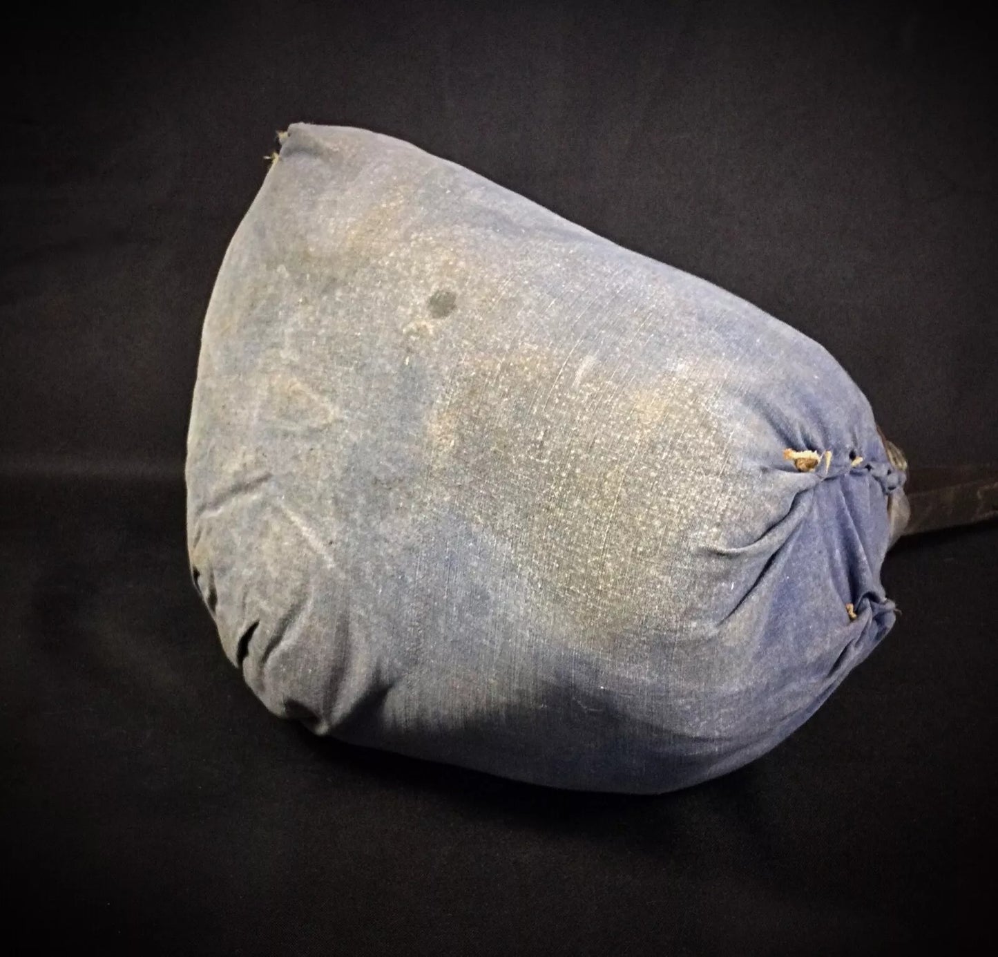 Close-up on the handle of the woven case and how it is attached.

