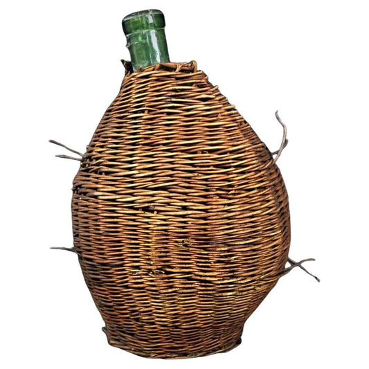 Full frontal view of the vintage demijohn bottle fully encased in its wicker cover.

