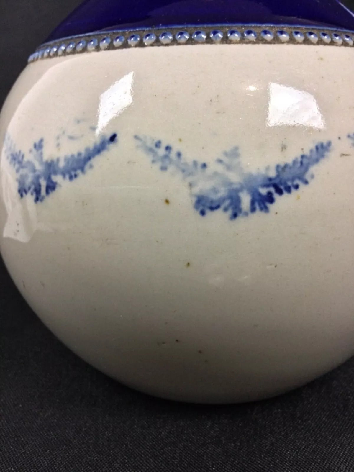 Detail shot showing the faded design and ceramic surface

