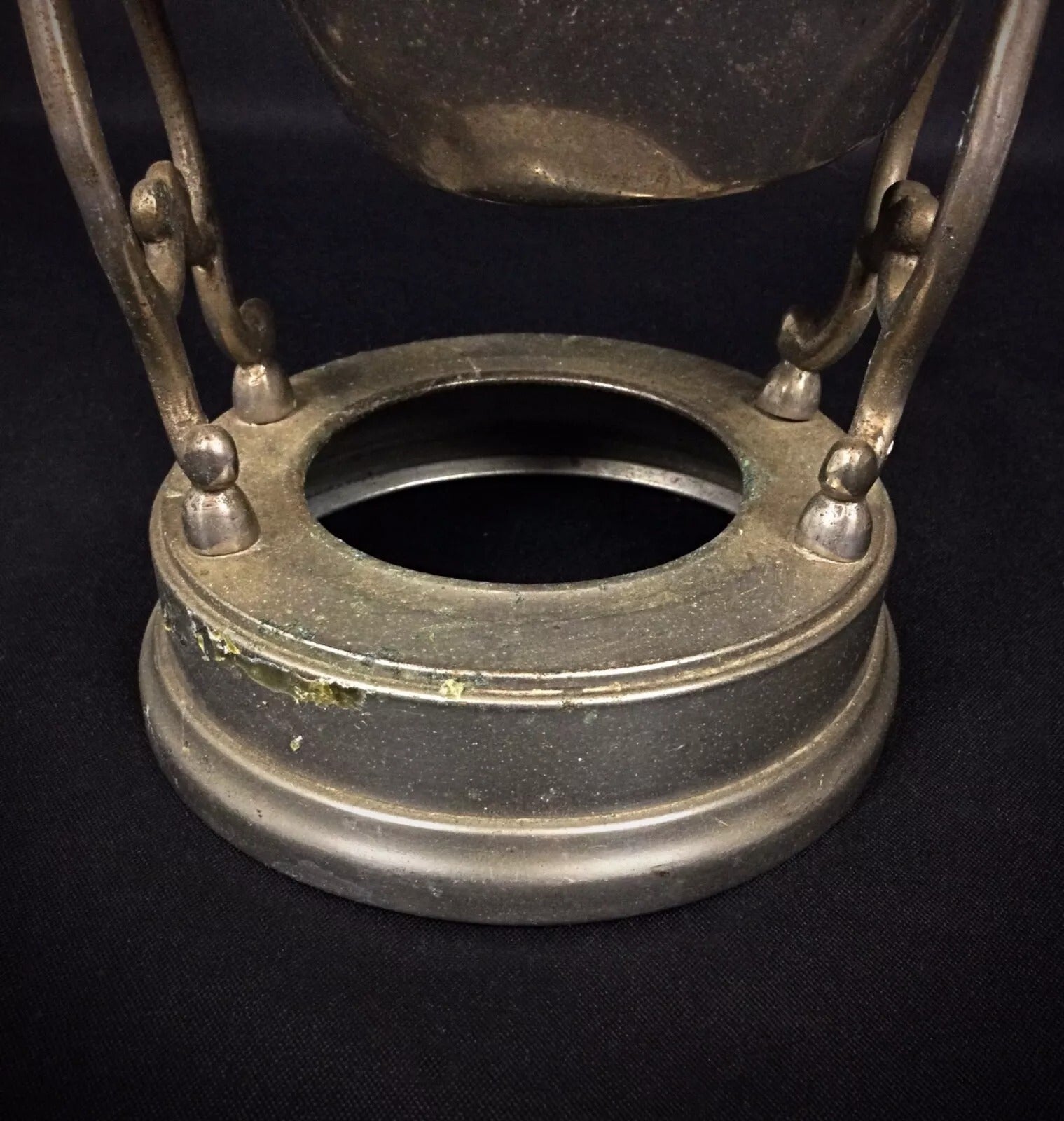 Close-up of elegant flowing lines and pierced metalwork characteristic of the Art Nouveau period on a vintage coffee pot