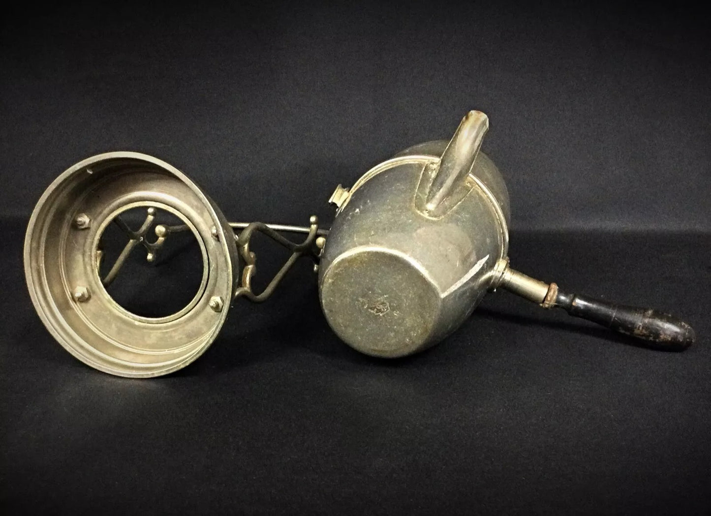 View of the pierced ajouré pattern allowing light to filter through the metal on this decorative antique coffee pot