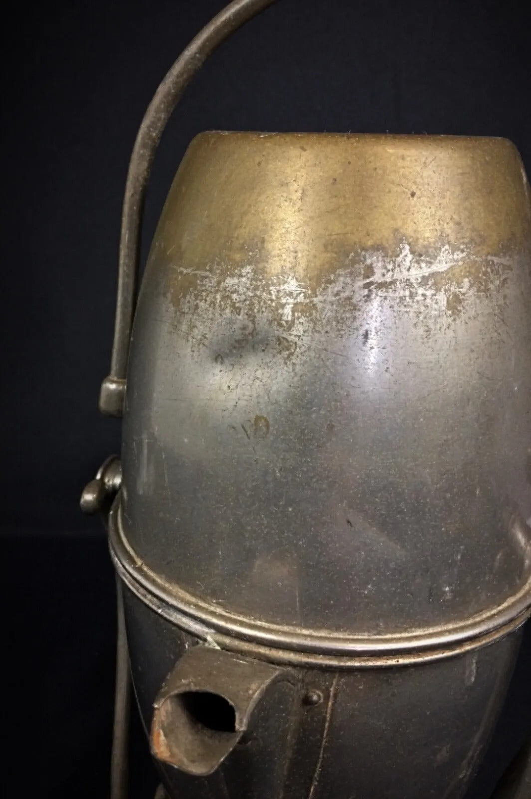 Aged metal surface with light oxidation and staining on an early 20th century tilt coffee pot in good vintage condition