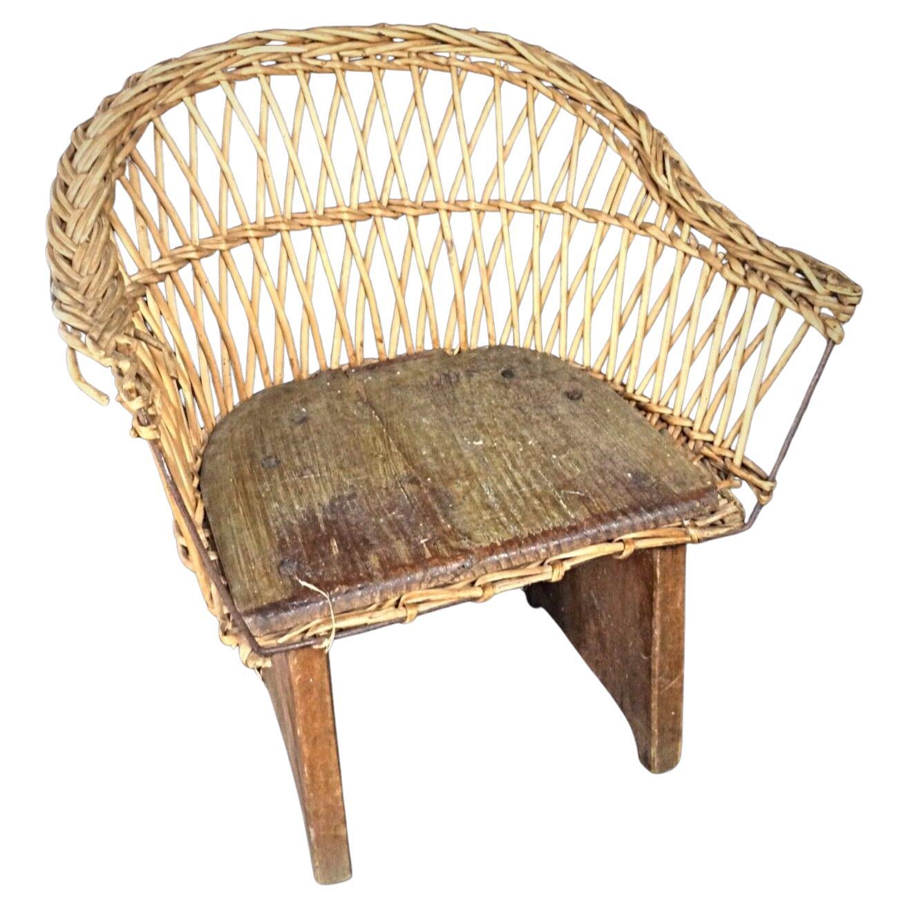 Antique 20th century children's chair crafted from wood and wicker full front view

