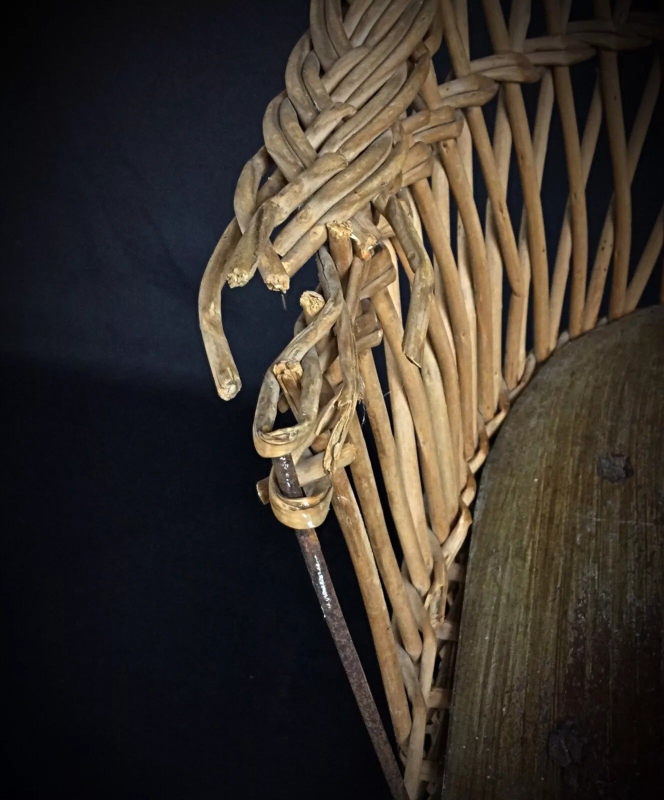Antique children's chair texture detail showing aged wood grain and woven wicker construction

