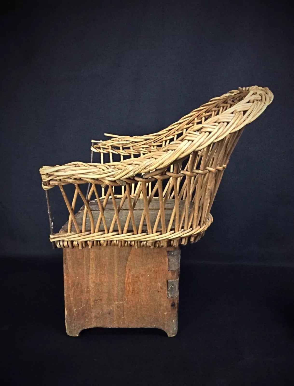 7. Rustic children's chair featuring warm wood tones and hand-woven wicker seat and back
