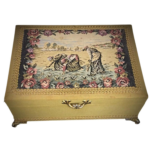 Antique small musical box with embroidered decoration and fleur-de-lys design on quadripod legs full view

