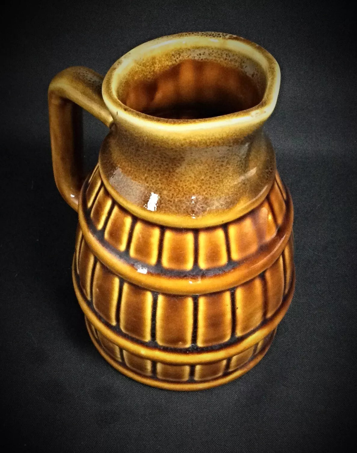 Handcrafted ceramic pitcher circa 20th century with tapered body and sculptural flame design

