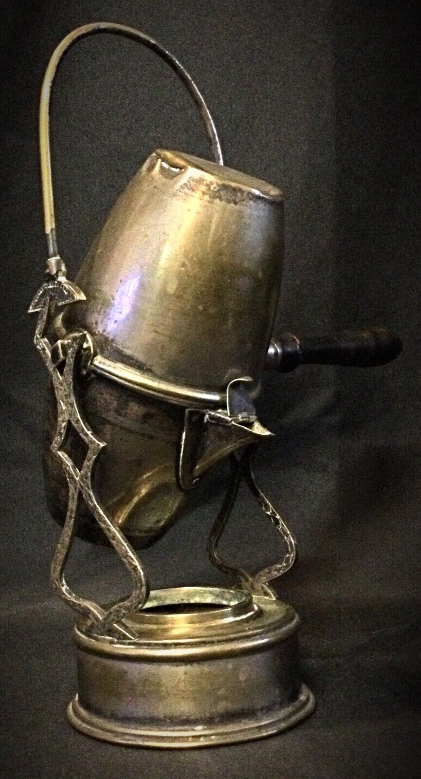 Close-up of the decorative handle on the antique coffee pot
