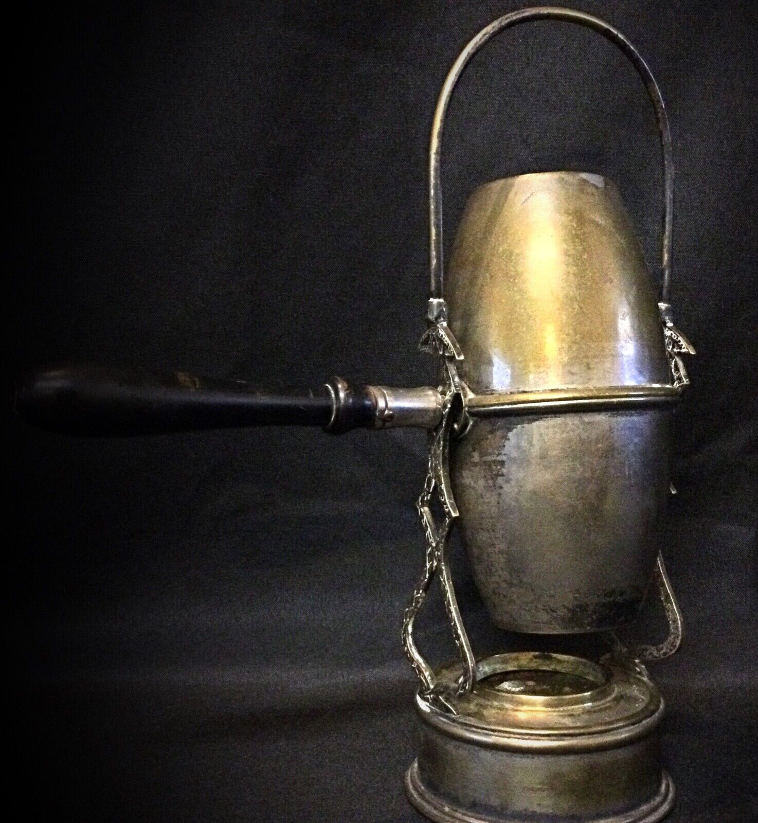 Side view of the vintage copper coffee pot with elegant curves
