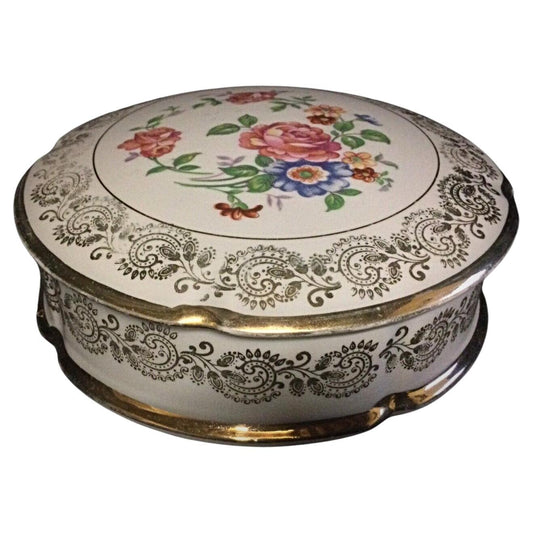 Vintage porcelain bonbonnière with floral decorations and gold trim
