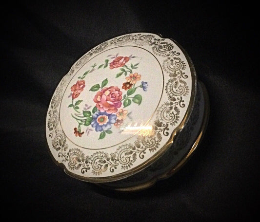 Close-up of the hand-painted floral motifs on the vintage bonbonnière
