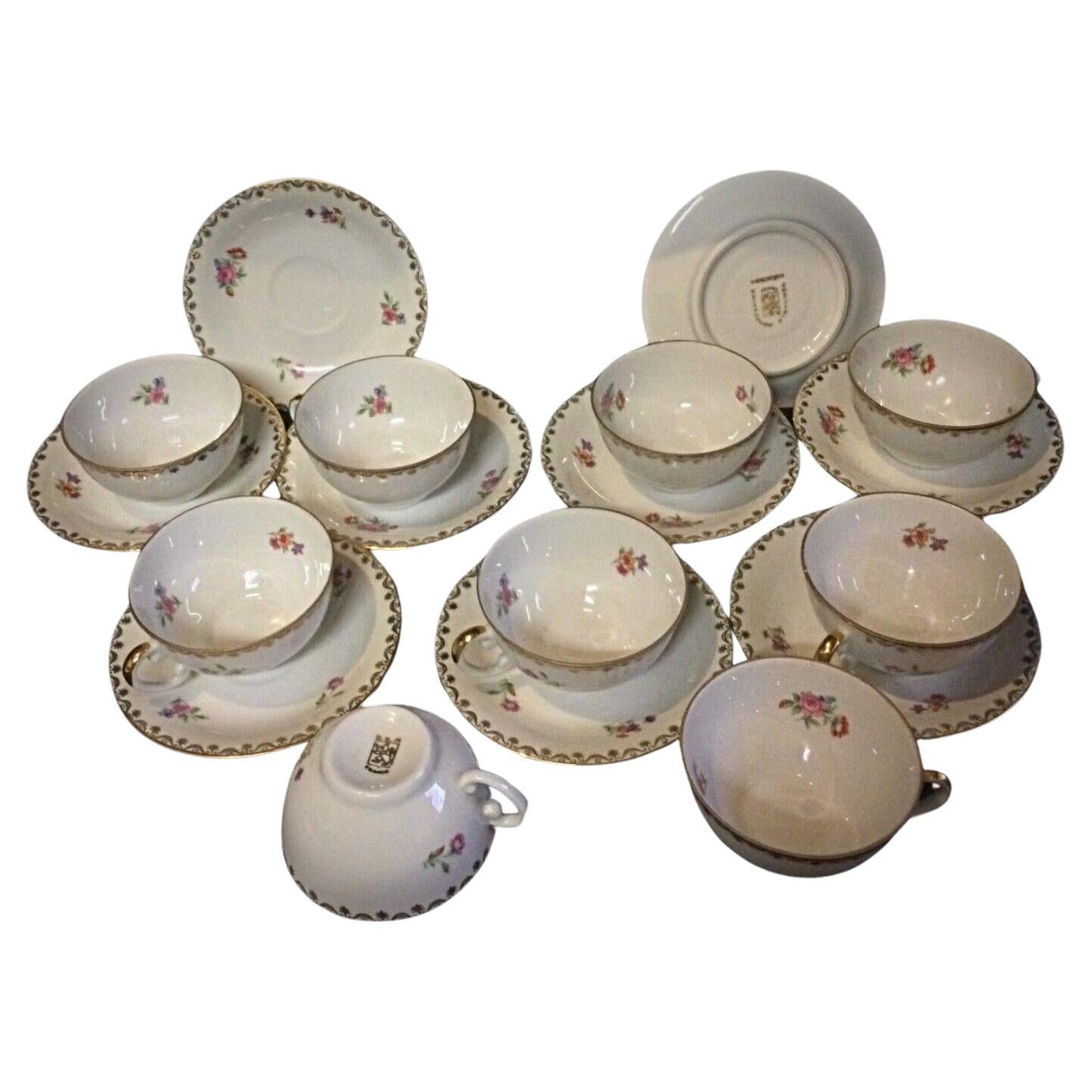 Vintage S.E.R France porcelain coffee cup and saucer with floral decorations and gold accents
