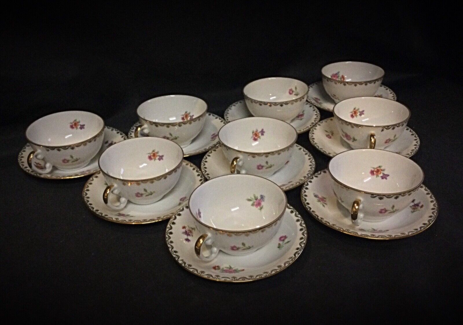 Close-up of gold-trimmed French porcelain coffee cup with floral design
