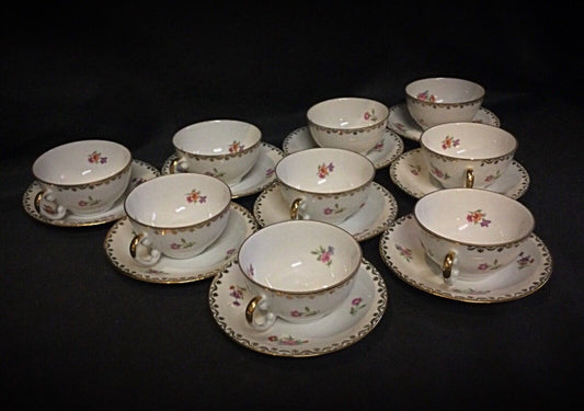 Close-up of gold-trimmed French porcelain coffee cup with floral design
