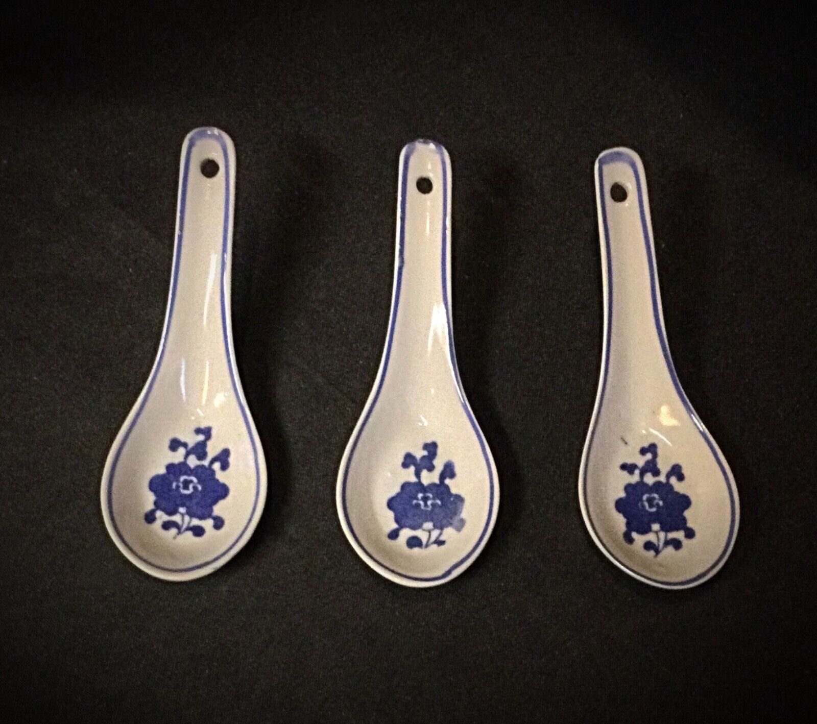 Porcelain rice bowls displayed on a wooden Asian-inspired table
